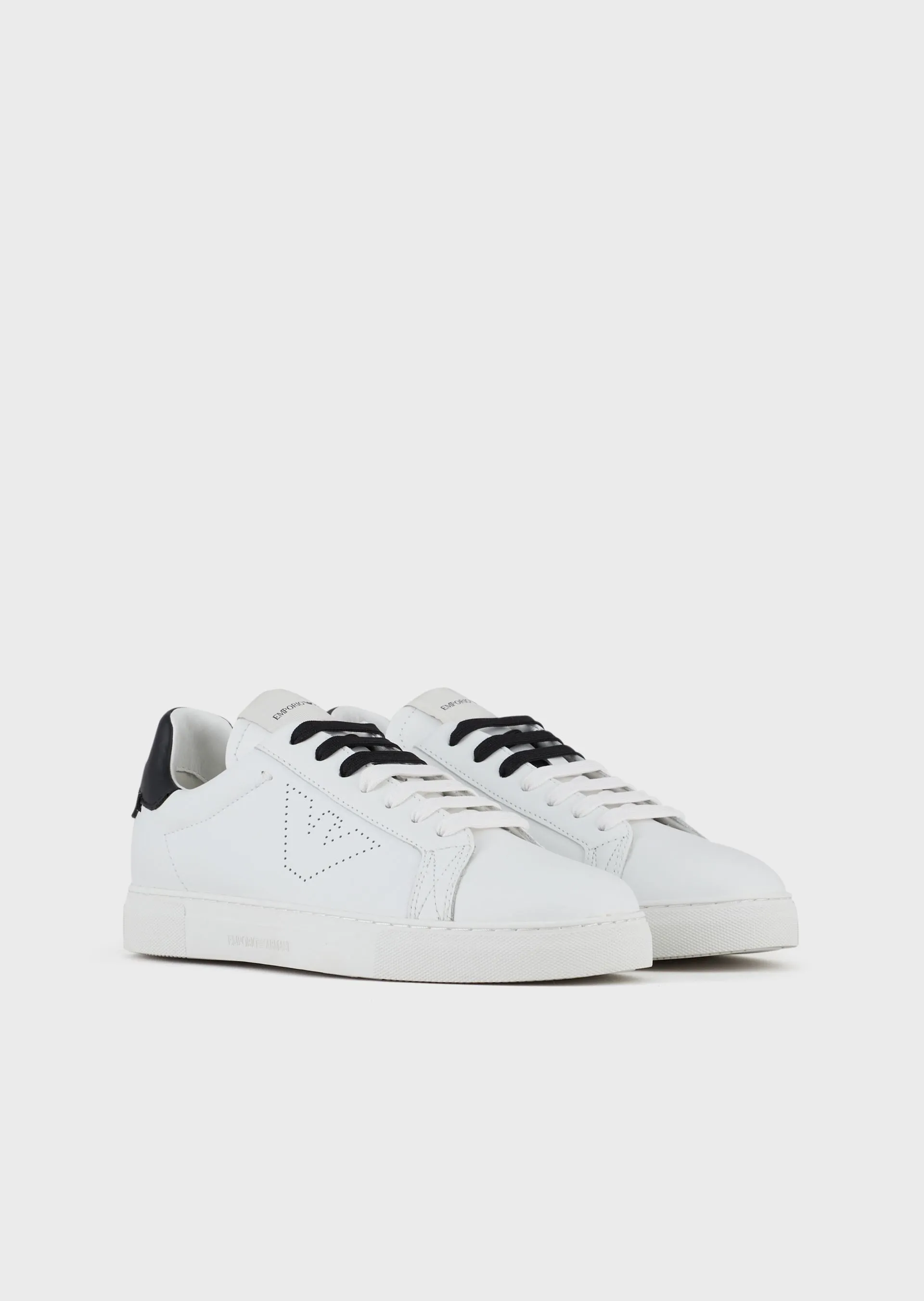 White leather trainers with two-tone laces and perforated design